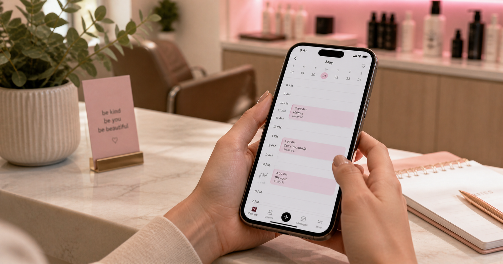 Hands holding phone with calendar showing fewer scheduled appointments