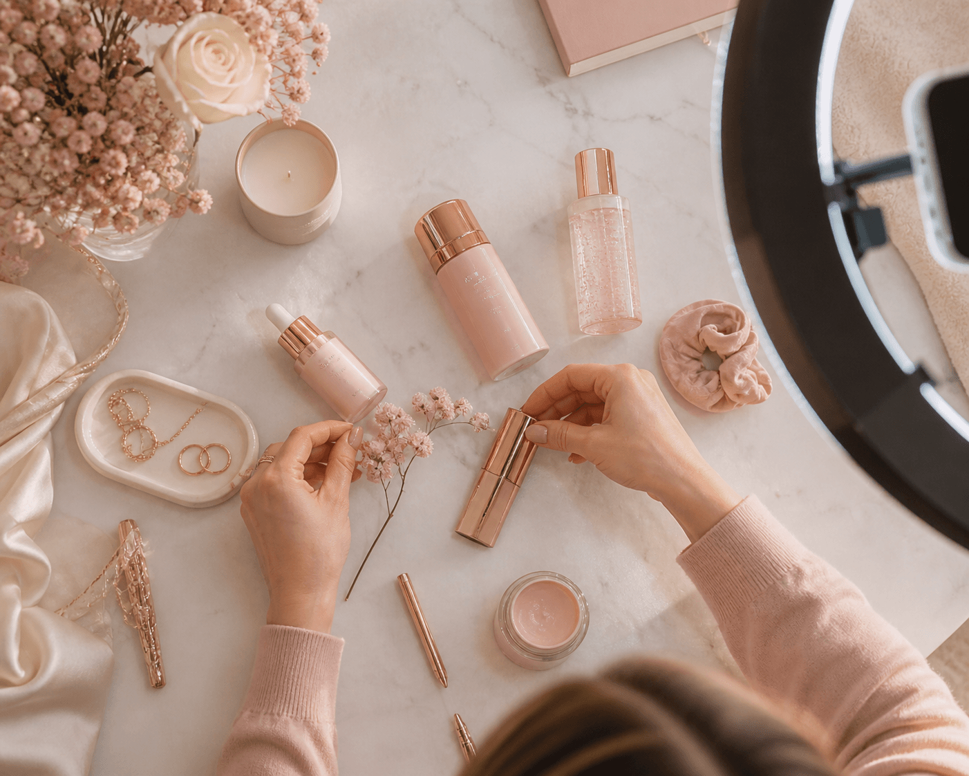 Hands styling beauty products in a flat-lay setup for Instagram content creation